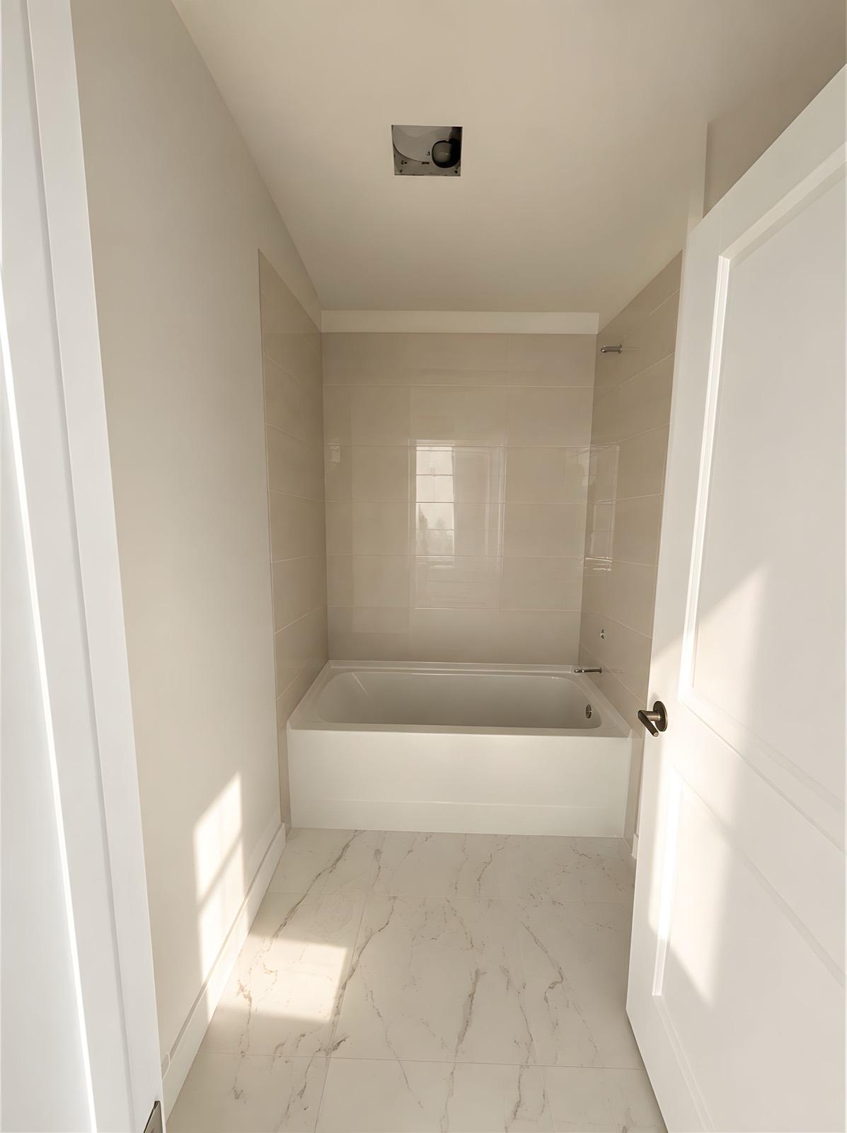 Guest bathroom of The Egret under construction &mdash; tiled tub surround